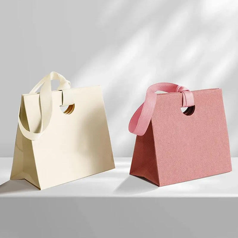 Personalized shopping paper bags with ribbon handles for boutiques