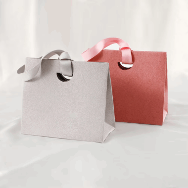 Personalized shopping paper bags with ribbon handles for boutiques