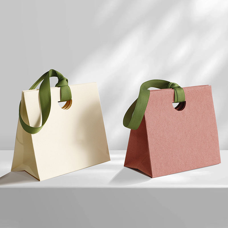 Personalized shopping paper bags with ribbon handles for boutiques