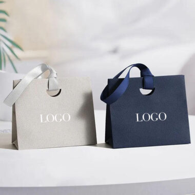 Personalized shopping paper bags with ribbon handles for boutiques
