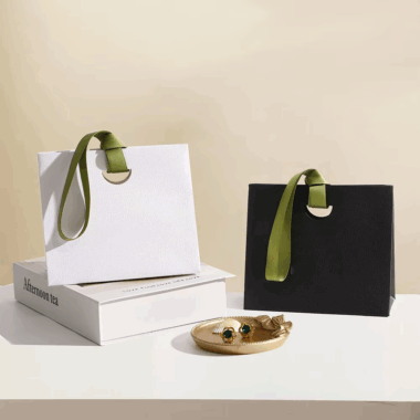 Personalized shopping paper bags with ribbon handles for boutiques