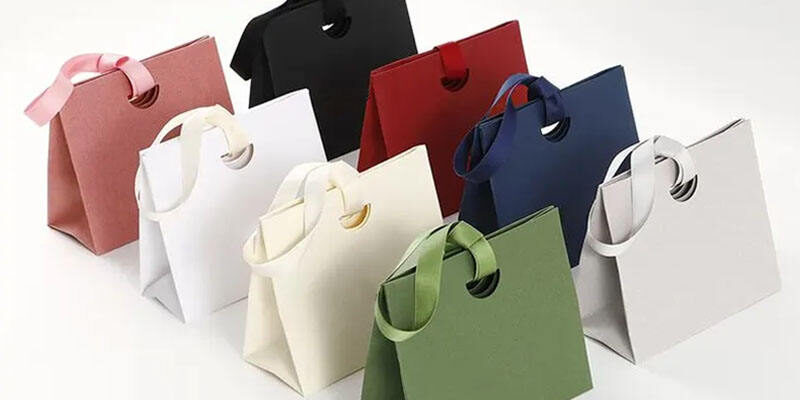 Personalized shopping paper bags with ribbon handles for boutiques