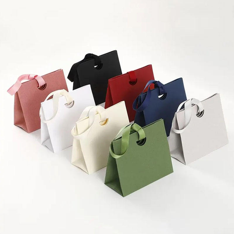 Personalized shopping paper bags with ribbon handles for boutiques