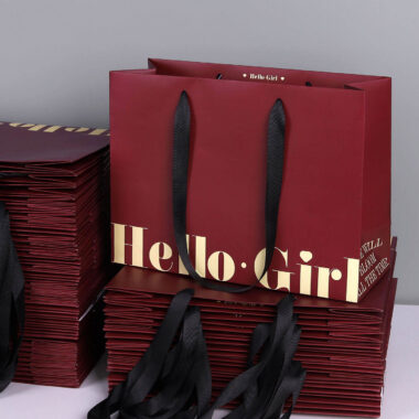 Luxury gift shopping paper bags with ribbon handles and custom logos