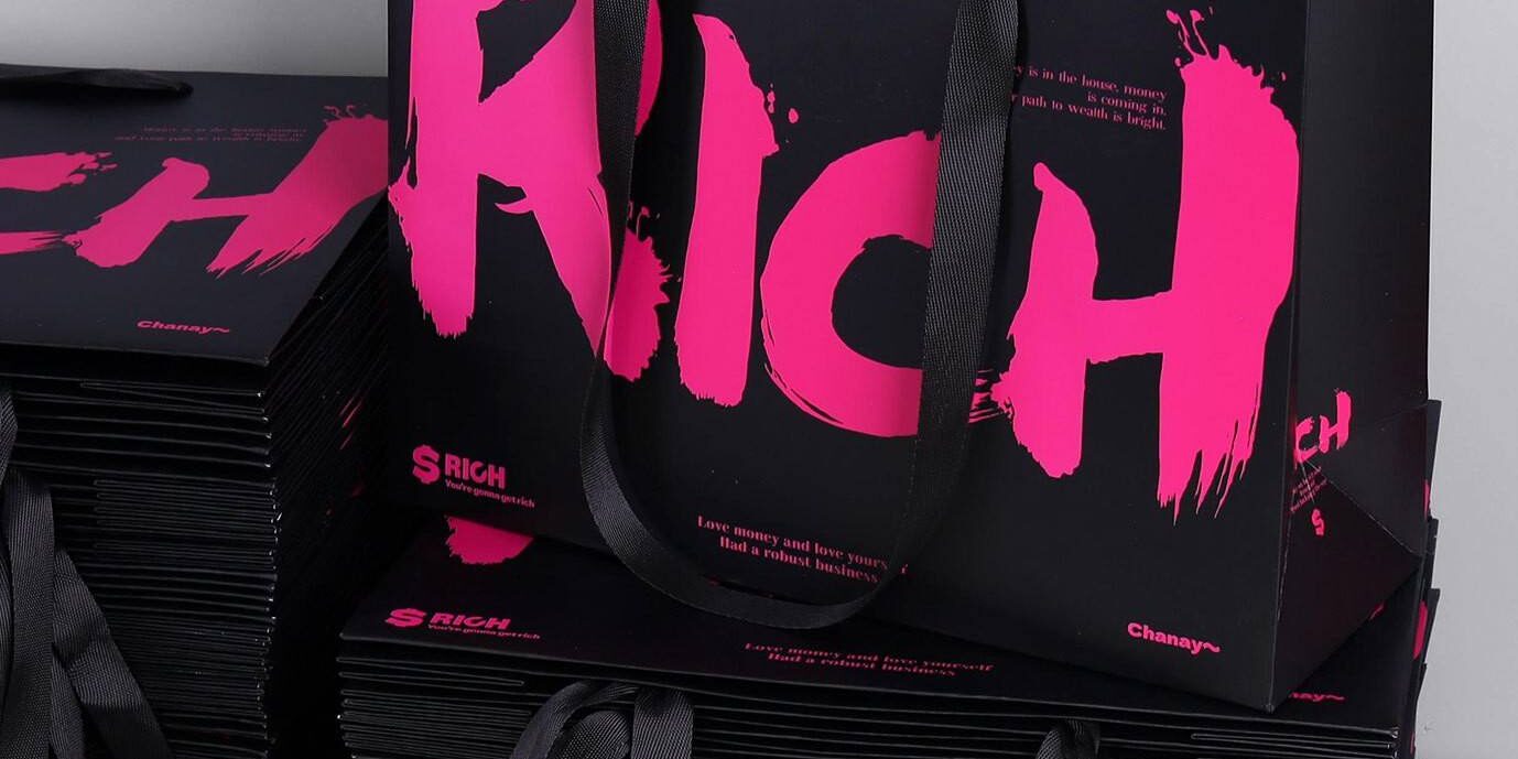 Luxury gift shopping paper bags with ribbon handles and custom logos
