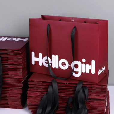 Luxury gift shopping paper bags with ribbon handles and custom logos